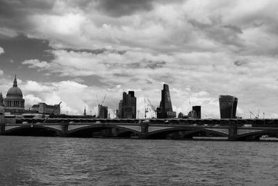 View of cityscape against cloudy sky