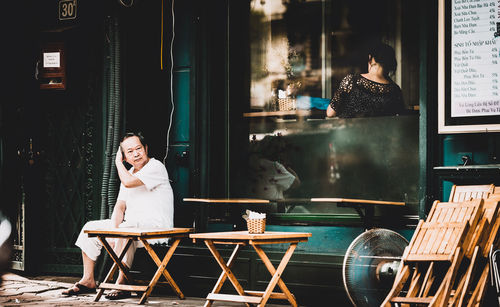 Portrait of young woman sitting outdoors