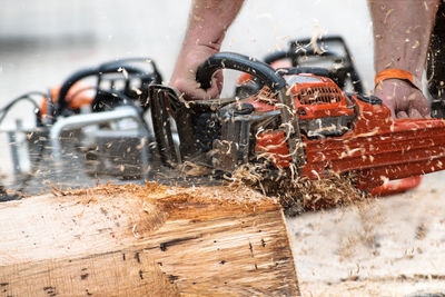 Man cutting tree trunk with chainsaw 