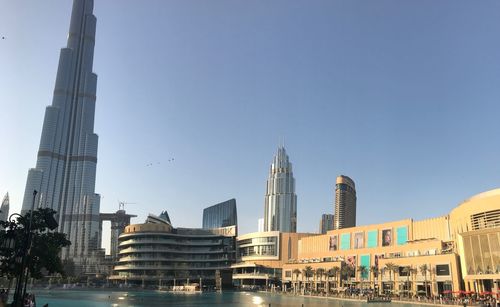 Buildings in city against clear sky