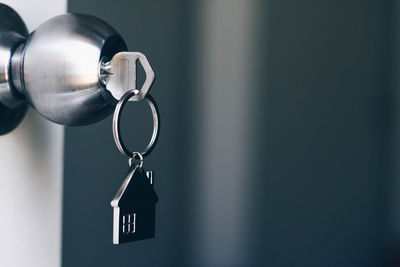 Close-up of key in door knob at home