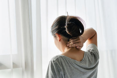 Side view of young woman photographing at home