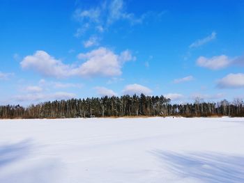 Scenic view of snow covered land against sky