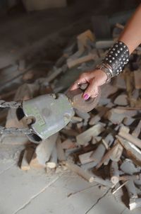 Cropped hand of woman holding metallic hook