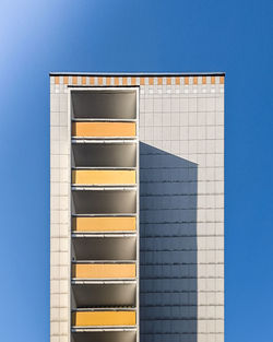 Low angle view of building against clear blue sky