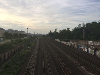 Railroad track against cloudy sky