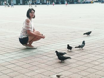 Boy eating birds on footpath