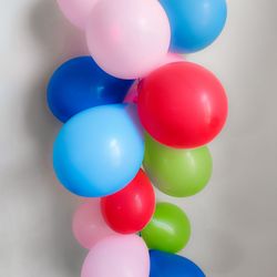 Close-up of multi colored balloons against white background