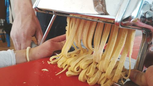 Cropped hands making pasta