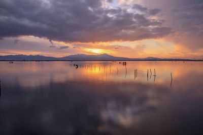 Scenic view of lake against sky during sunset