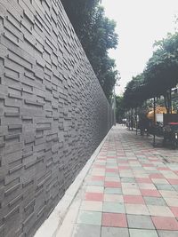 Footpath amidst buildings against sky