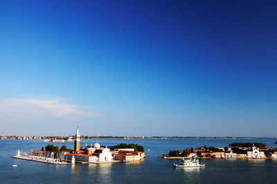 Mid distance view of san giorgio maggiore in grand canal against blue sky