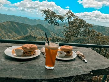 Breakfast on table against mountains
