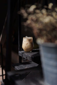 An iced latte coffee in the clear glass with dark tone.