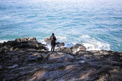 Man on sea shore against sky