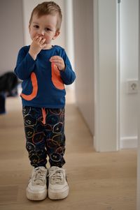 Toddler wearing his father shoes - son and father concept