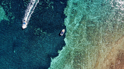 High angle view of boat on rock in sea