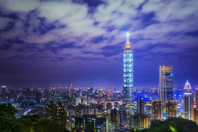 Illuminated buildings in city against sky at night.  taipei, taiwan - dec 17, 2019