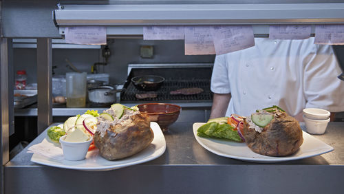 Pub food ready to be served in commercial kitchen at british pub