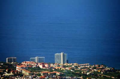 High angle shot of townscape against blue sea