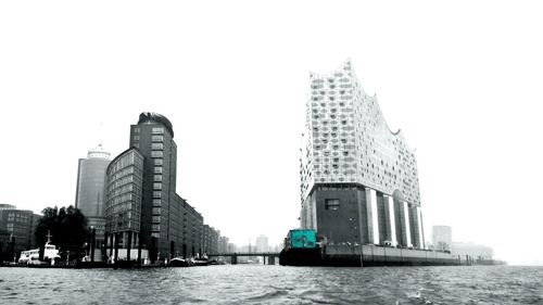 Buildings in city against clear sky