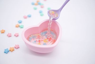 High angle view of candies against white background