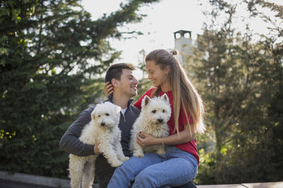 Portrait of woman with dog against people