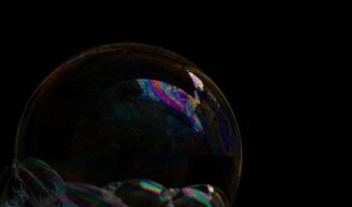 Close-up of bubbles against black background