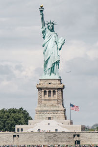 Low angle view of statue against cloudy sky