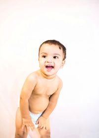 Portrait of happy boy against white background