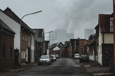 Street amidst buildings in city against sky