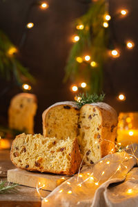 Traditional italian christmas cake panettone on a rustic table with festive holiday decorations