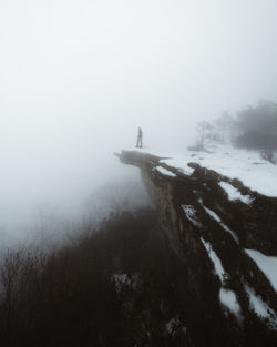 Scenic view of snow covered land against sky