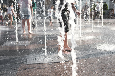 Low section of man splashing water