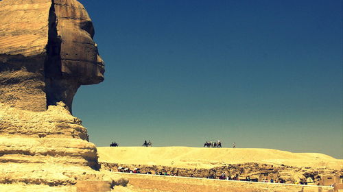 Great sphinx of giza against clear blue sky