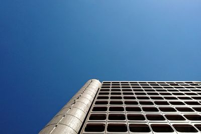 Low angle view of modern building against clear blue sky