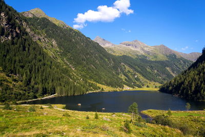 Scenic view of lake and mountains against sky