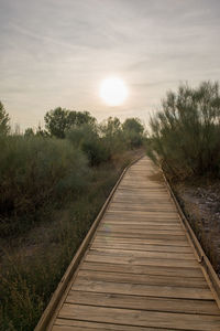 View of empty road against sky during sunset