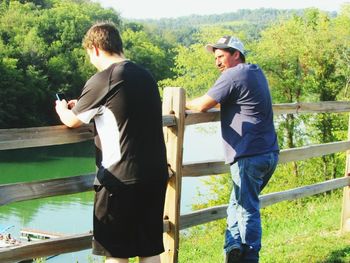 Woman standing on tree trunk