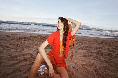 Midsection of woman standing at beach