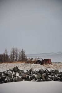 Snow covered landscape against clear sky