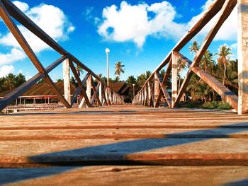 Wooden footbridge against sky