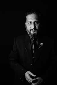 Low angle view of young man against black background