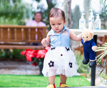 Cute boy with toy against blurred background