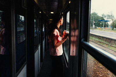 Man standing on train window