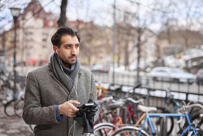 Elegant man with smartphone on street