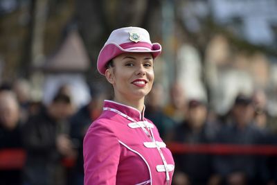 Close-up of woman with pink mask standing outdoors