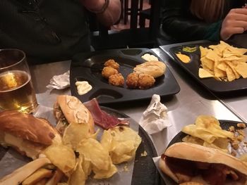 Midsection of person preparing food on table at restaurant