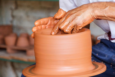 Close-up of man making pot