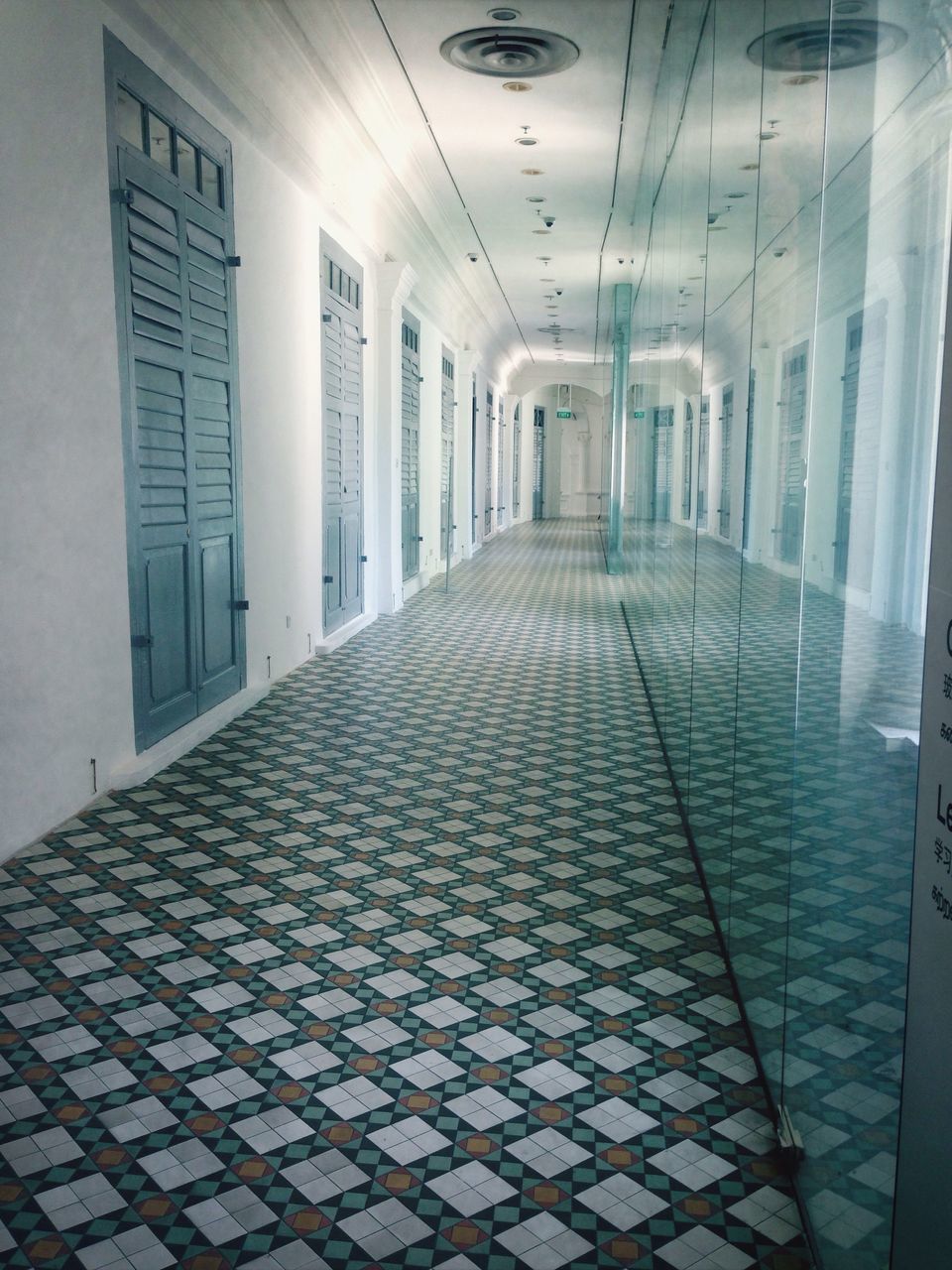 indoors, architecture, built structure, corridor, tiled floor, flooring, empty, the way forward, ceiling, absence, window, building, diminishing perspective, reflection, tile, sunlight, wall - building feature, glass - material, no people, floor